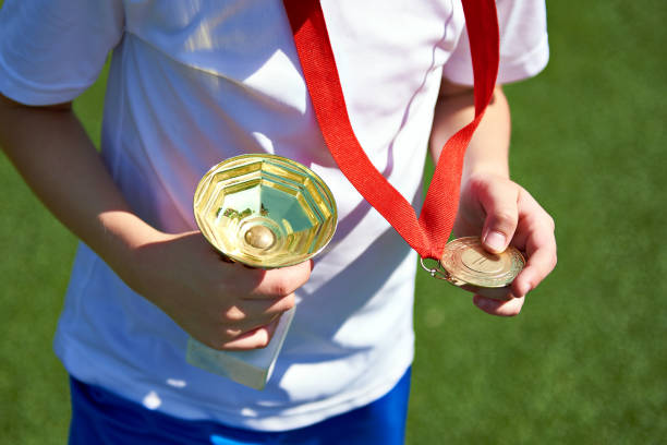 istock Winner boy sportsman with cup and medal 814202848