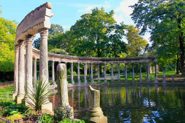 Romantic old classical columns ruins between Idyllic French ornamental Garden pond lake, green lush foliage dramatic colorful landscape, Monceau public park panorama, Paris, France Romantic old classical columns ruins between Idyllic French ornamental Garden pond lake, green lush foliage dramatic colorful landscape, Monceau public park panorama, Paris, France giverny stock pictures, royalty-free photos & images