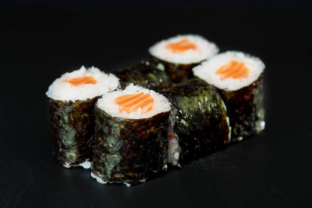 istock Sliced Sushi Role on Black Background. 814276442
