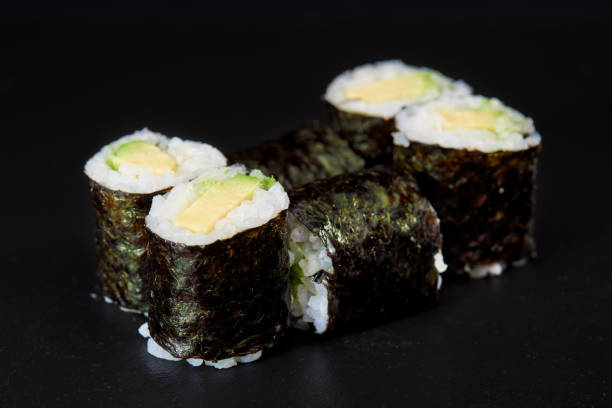 istock Sliced Sushi Role on Black Background. 814276756