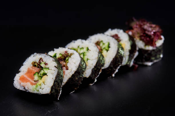 istock Sliced Sushi Role on Black Background. 814279042