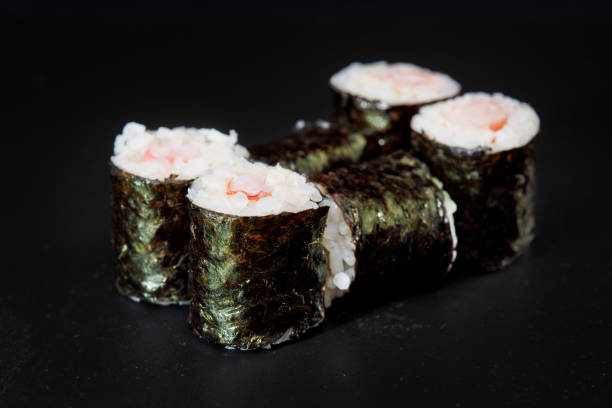 istock Sliced Sushi Role on Black Background. 814279076