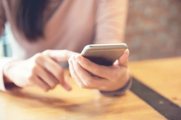 istock Woman using smartphone at modern coffee shop. 814282218