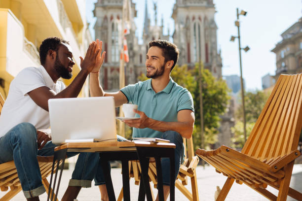 istock Smart cheerful guy giving his friend a high five 814298494