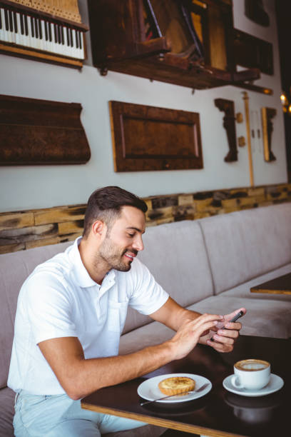 istock Young man having cup of coffee and pastry 814298660