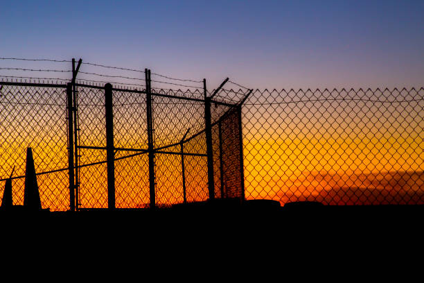 istock Chain link fence with barbed wire 814304486