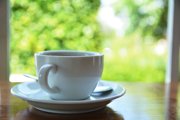istock Coffee white cup and green boken background 814306838