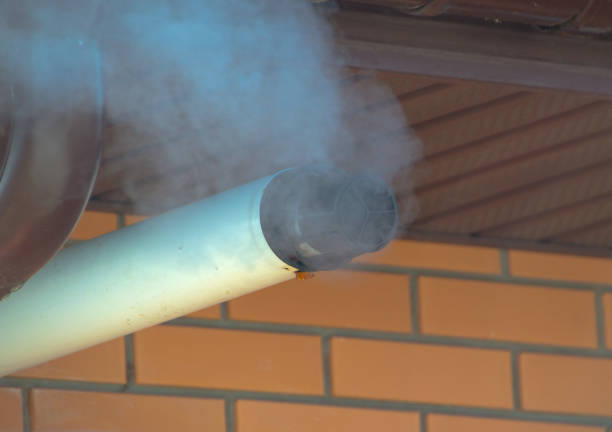 a cloud of smoke escapes from the chimney.