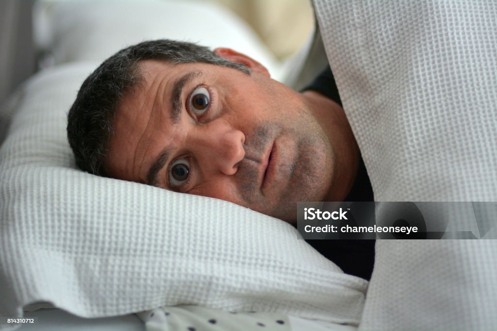 Sleeplessness man Sleeplessness man suffering from Insomnia sleep disorder. Real people. Copy space. Men Stock Photo