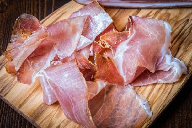 istock Prosciutto on the wooden board. 814311022