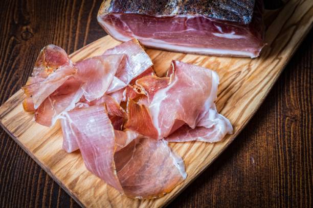 istock Prosciutto on the wooden board. 814311028