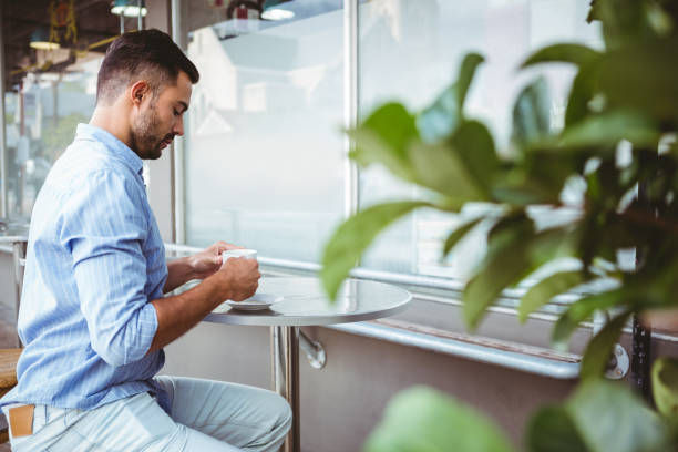 istock Businessman holding a cup of coffee 814314080