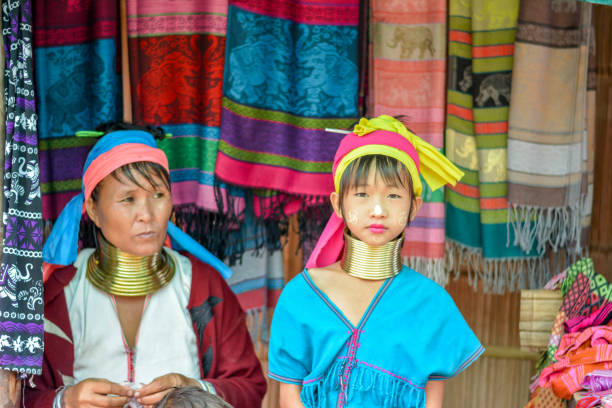 Long Neck Village in Thailand CHIANG MAI, THAILAND - July 10, 2017: Long Neck woman in a tribe near Chiang Mai in Northern Thailand. kayan neck rings stock pictures, royalty-free photos & images