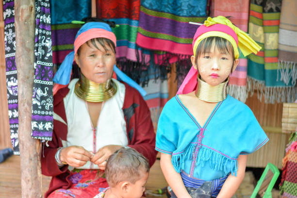 Long Neck Village in Thailand CHIANG MAI, THAILAND - July 10, 2017: Long Neck woman in a tribe near Chiang Mai in Northern Thailand. kayan neck rings stock pictures, royalty-free photos & images