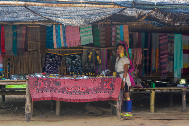 Long Neck Village in Thailand CHIANG MAI, THAILAND - July 10, 2017: Long Neck woman in a tribe near Chiang Mai in Northern Thailand. kayan neck rings stock pictures, royalty-free photos & images