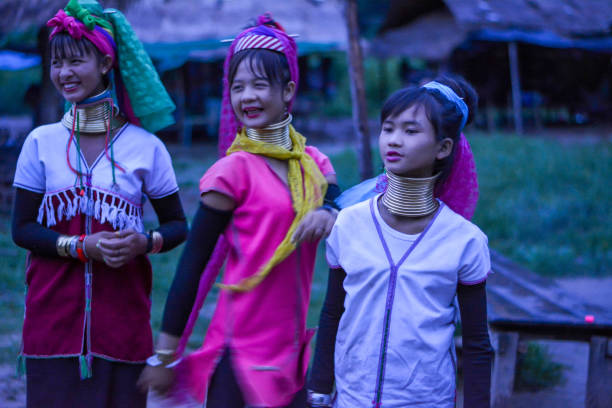 Long Neck Village in Thailand CHIANG MAI, THAILAND - July 10, 2017: Long Neck woman in a tribe near Chiang Mai in Northern Thailand. kayan neck rings stock pictures, royalty-free photos & images
