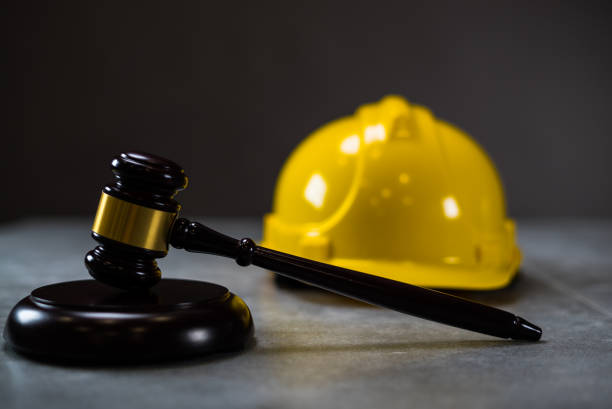 istock Law concept. Yellow Helmet and Judges hammer 814319862