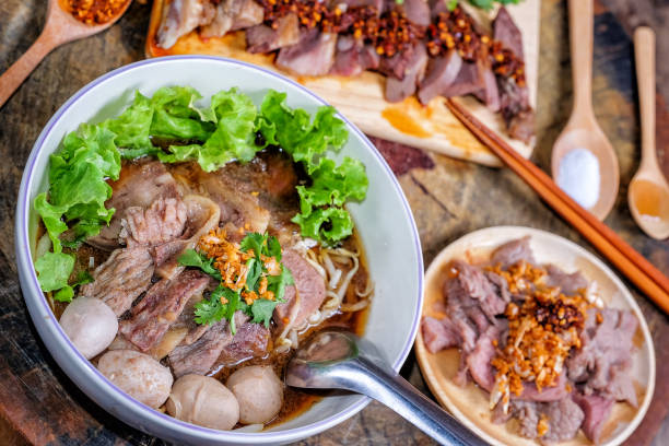 タイ料理ウッドの背景上の牛肉麺 - thai cuisine chili cilantro seasoning ストックフォトと画像