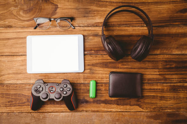 istock Tablet and music headphone next the joystick USB key and glasses 814329120