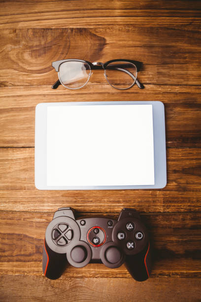istock Tablet next to joystick and glasses 814329246