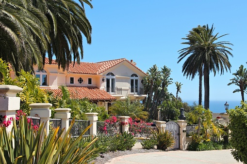 Luxury California residential home as seen from public road in Malibu, USA. Real estate rates in California have grown 105 percent since 1990.
