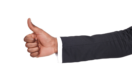 Thumb up is sign of successful businessman. Close-up of positive sign, like, agreement concept. Isolated on white background