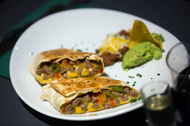 istock Tex-mex burrito with meat in sause on plate 814339198