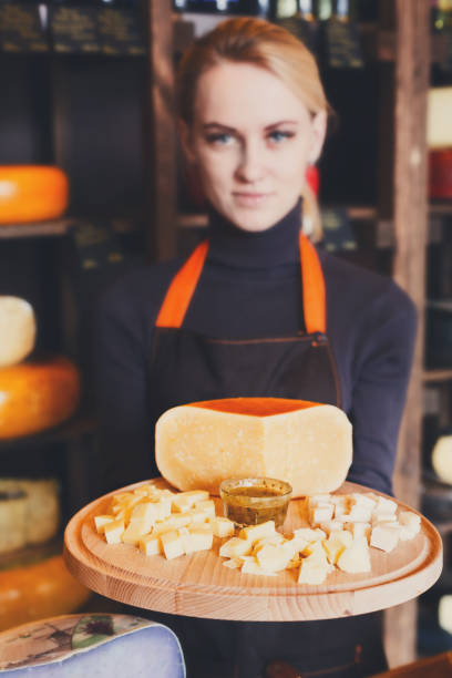 istock Cheese platter in shop assistant hands 814340250