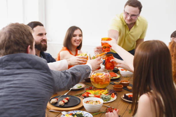 istock People say cheers clink glasses at festive table dinner party 814342420
