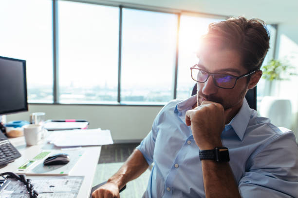 istock Businessman sitting at his desk in office. 814342880