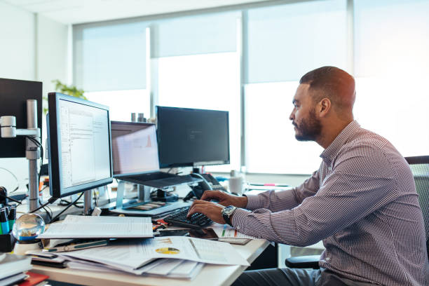 istock Businessman working on computer at his desk in office. 814342932