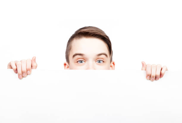 istock Teen boy showing blank banner isolated on white 814343214