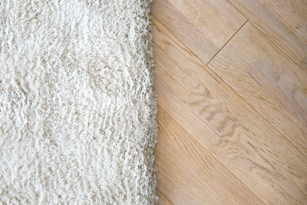 istock Wooden laminate floor and soft carpet 814343278