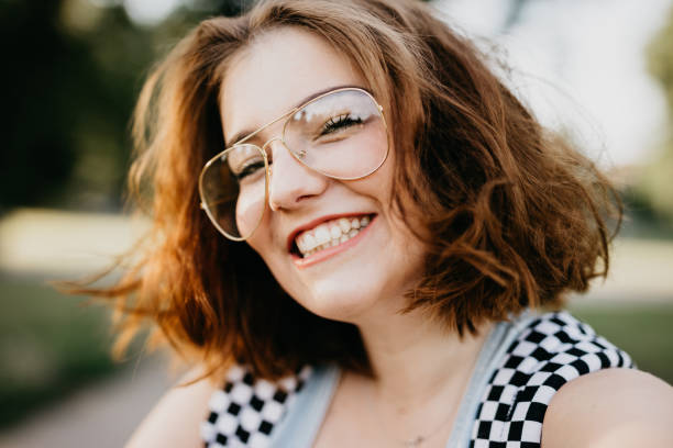 istock Smiling young woman is taking a selfie 814346132