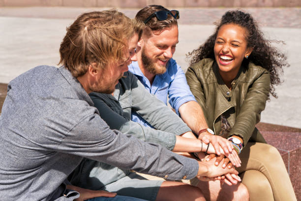 istock Group of smiling friends holding hands 814346580