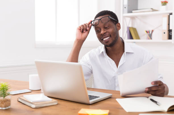 istock Black businessman in office, work with laptop and documents 814347244