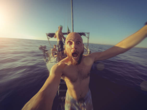 Action POV selfie: diving from a yacht sailing boat