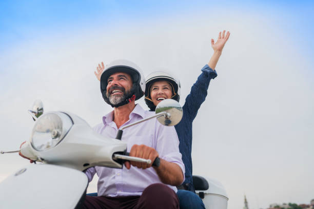 istock Happy Mature Couple Driving Scooter 814363074