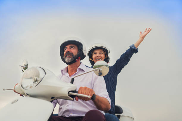istock Happy Mature Couple Driving Scooter 814363662
