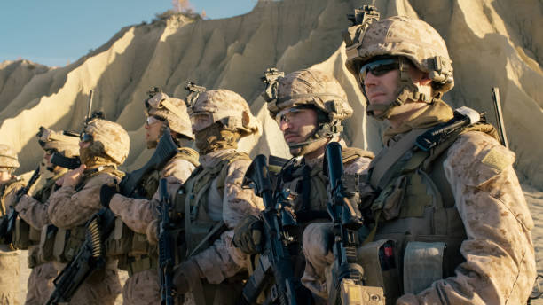 Group of Fully Equipped Soldiers Standing in a Line in the Desert. Group of Fully Equipped Soldiers Standing in a Line in the Desert. afghanistan army stock pictures, royalty-free photos & images