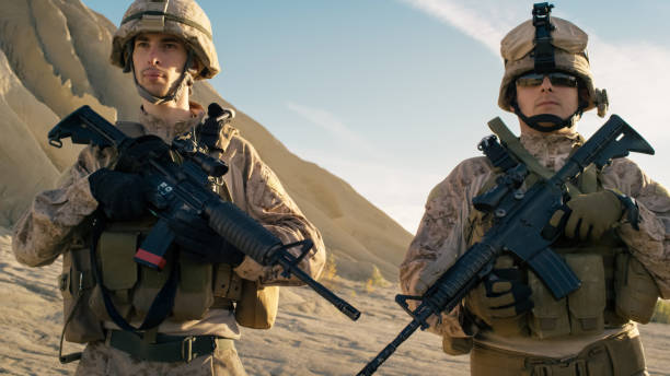 istock Two Fully Equipped Soldiers Standing in a Line in the Desert. 814367138