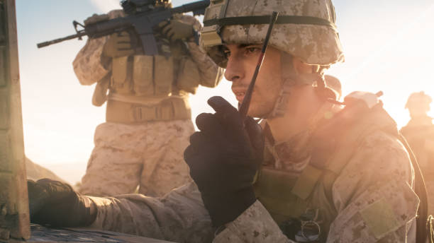 istock Soldier is Using Radio For Communication During Military Operation in the Desert 814367180