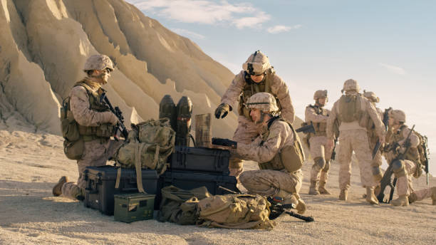 istock Soldiers are Using Laptop Computer for Surveillance During Military Operation in the Desert. 814367260