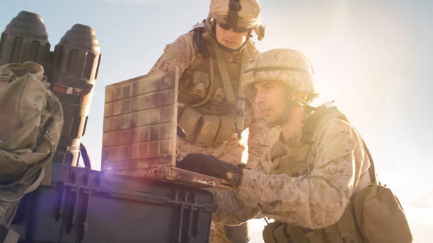 istock Close-up shot of Soldier is Using Laptop Computer for Surveillance During Military Operation in the Desert. 814367262