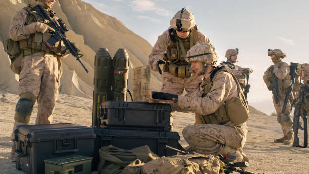 istock Soldiers are Using Laptop Computer for Surveillance During Military Operation in the Desert. 814367280
