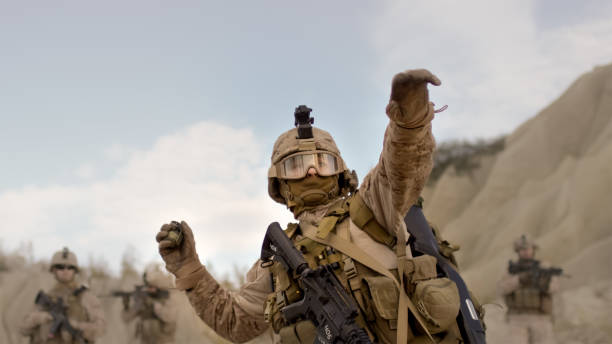 istock Soldier Throwing a Grenade during Combat in the Desert. 814367290