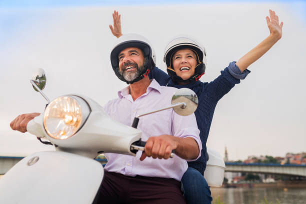 istock Happy Mature Couple Driving Scooter 814368394