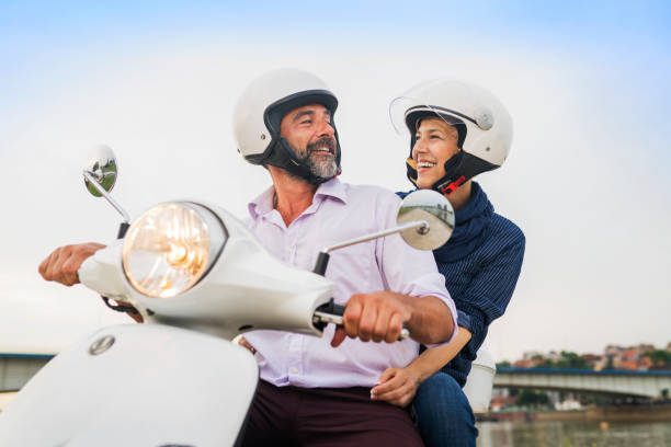 istock Happy Mature Couple Driving Scooter 814368396