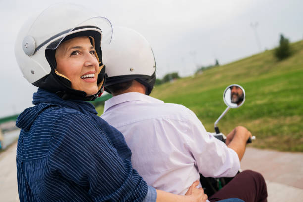 istock Happy Mature Couple Driving Scooter 814368730