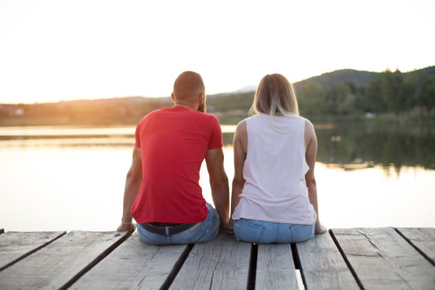 istock Romantic Couple sitting on the pier 814369336